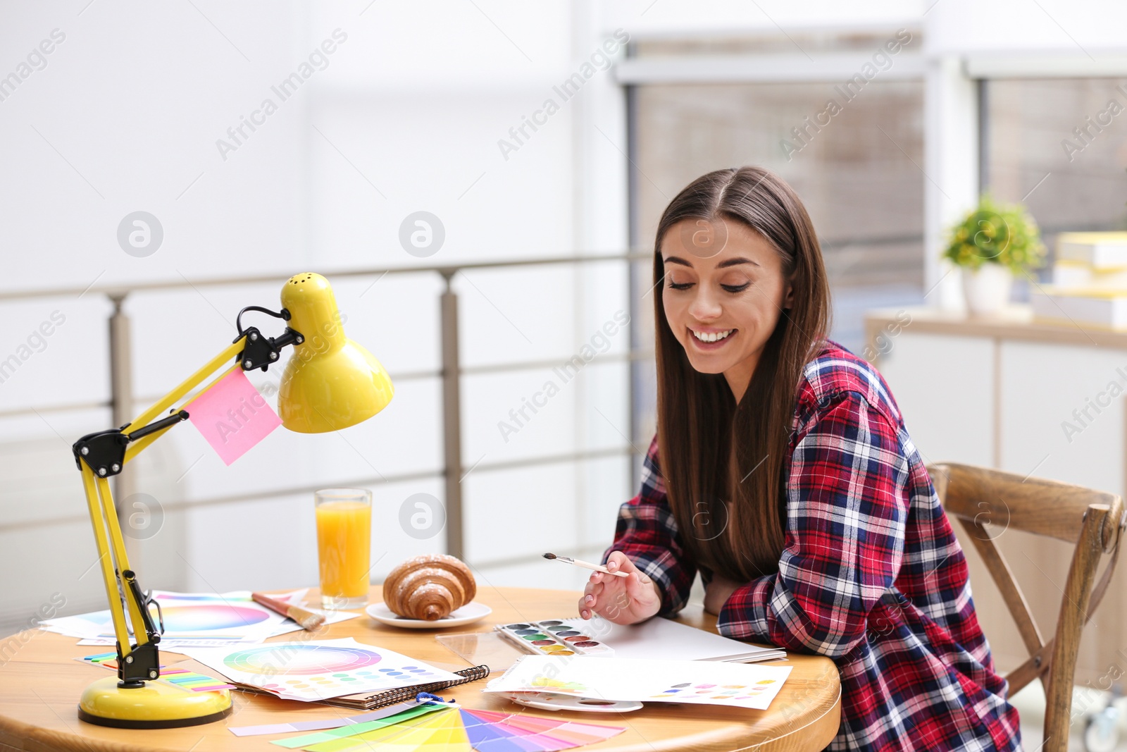 Photo of Female designer working at desk in office