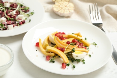 Photo of Delicious fresh carrot salad served on white wooden table, closeup