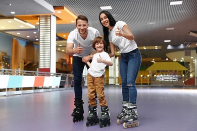 Happy family spending time at roller skating rink