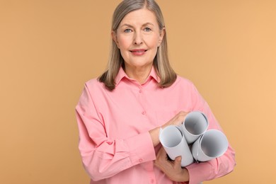 Photo of Portrait of architect with drafts on beige background