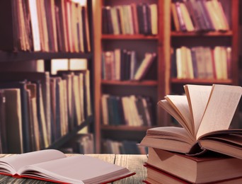 Image of Different books on wooden table in library