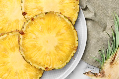 Slices of tasty ripe pineapple on table, top view