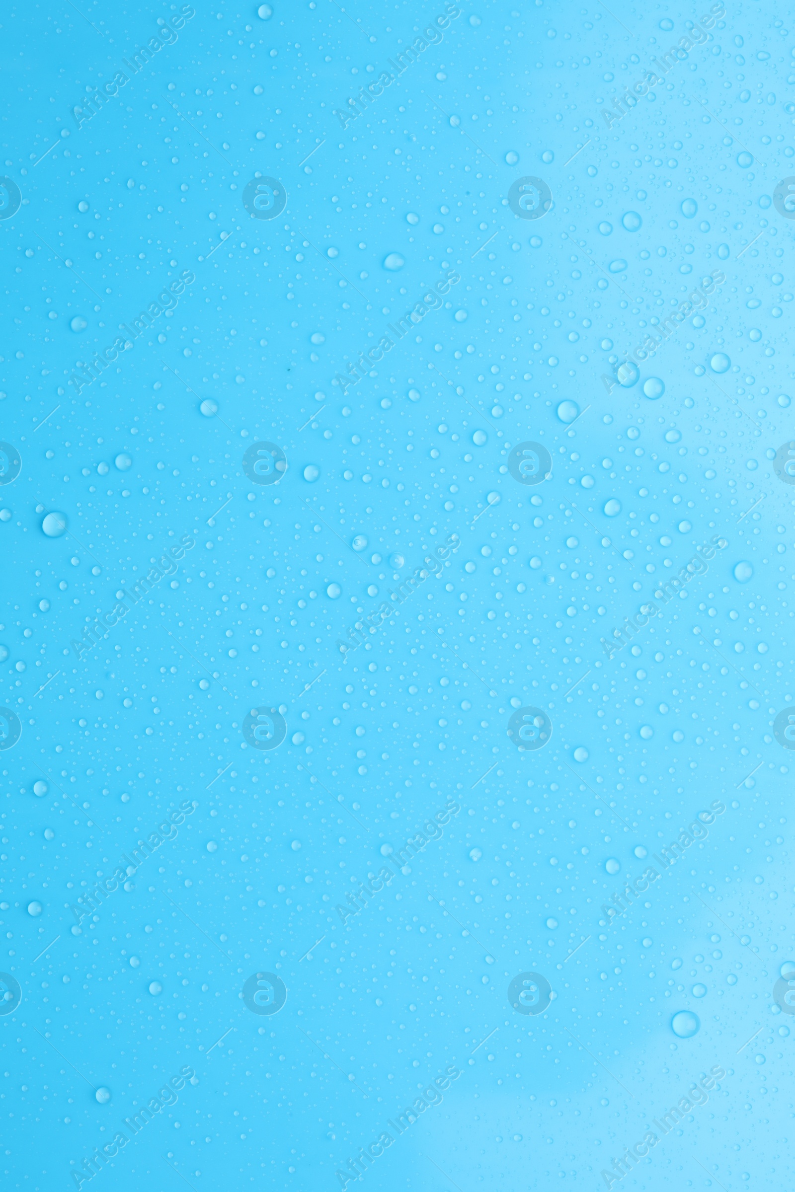 Photo of Water drops on light blue background, top view