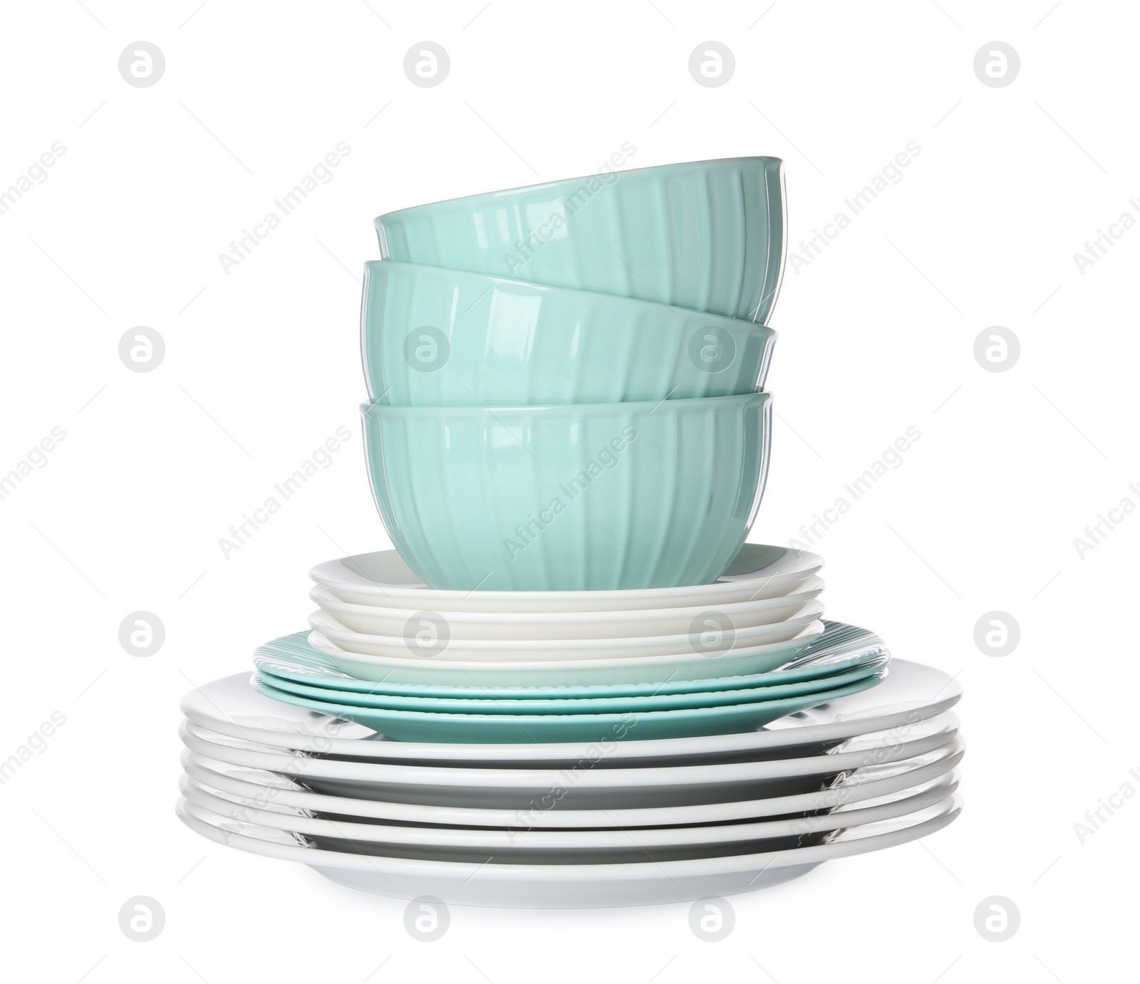 Photo of Beautiful ceramic plates and bowls isolated on white