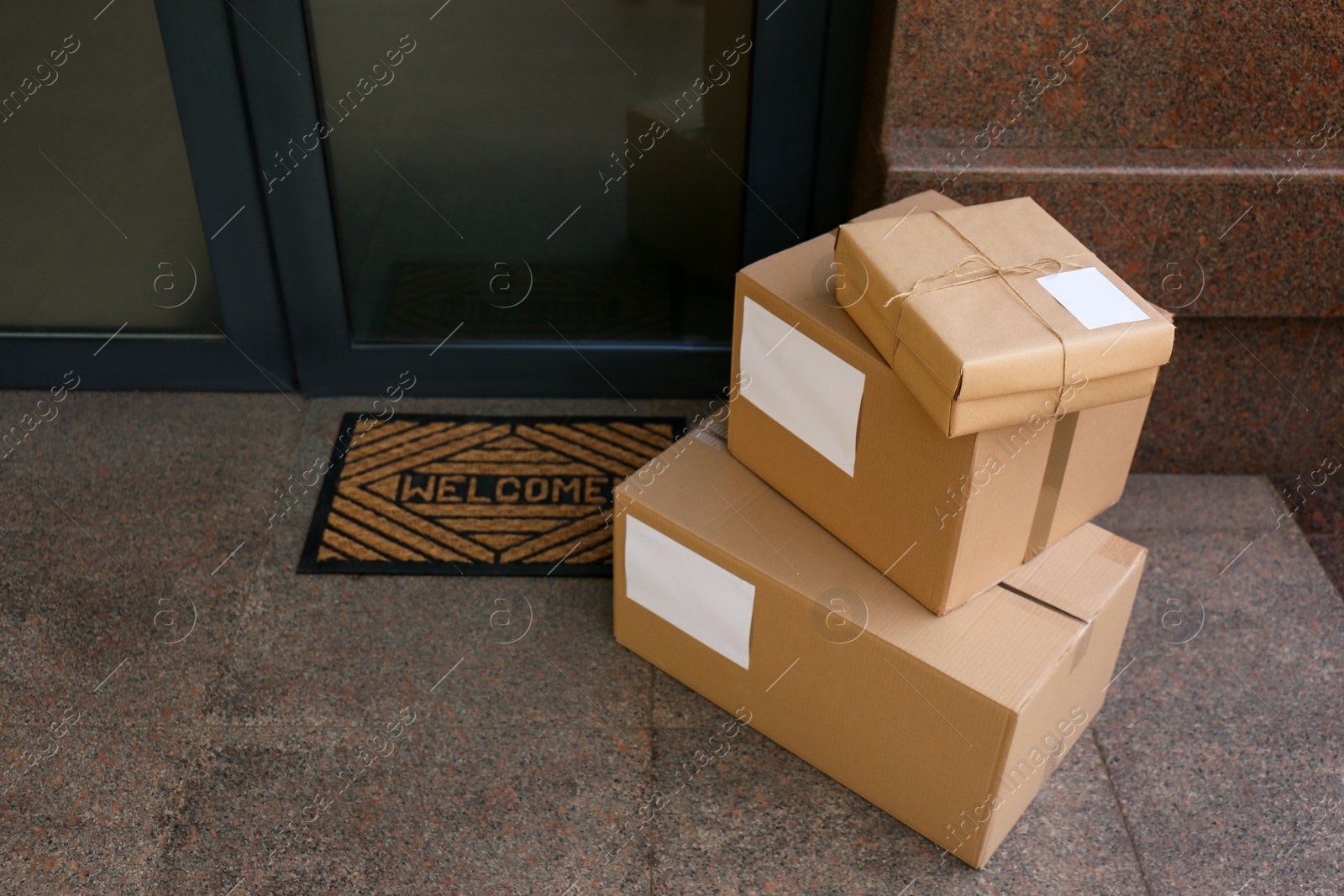 Photo of Delivered parcels on door mat near entrance