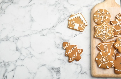 Tasty homemade Christmas cookies and board on table, top view