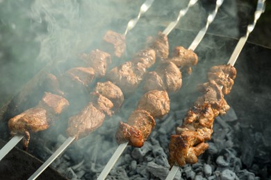 Cooking delicious meat on metal brazier outdoors