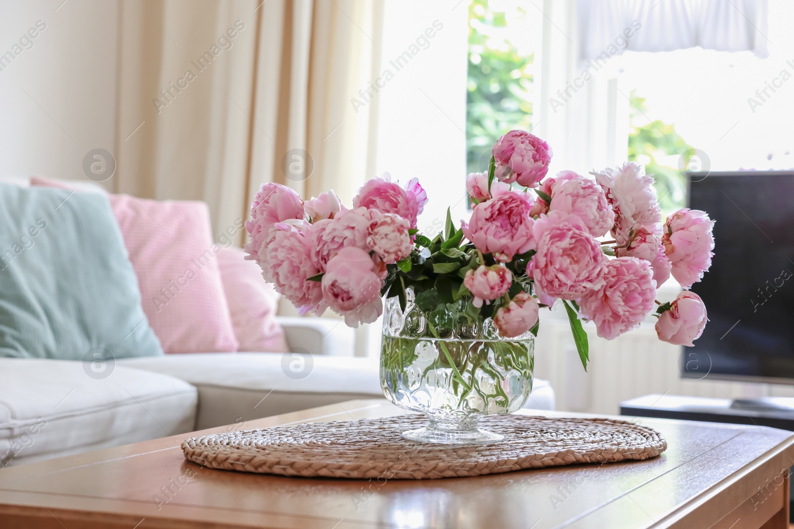 Photo of Beautiful pink peonies in vase on table at home, space for text. Interior design