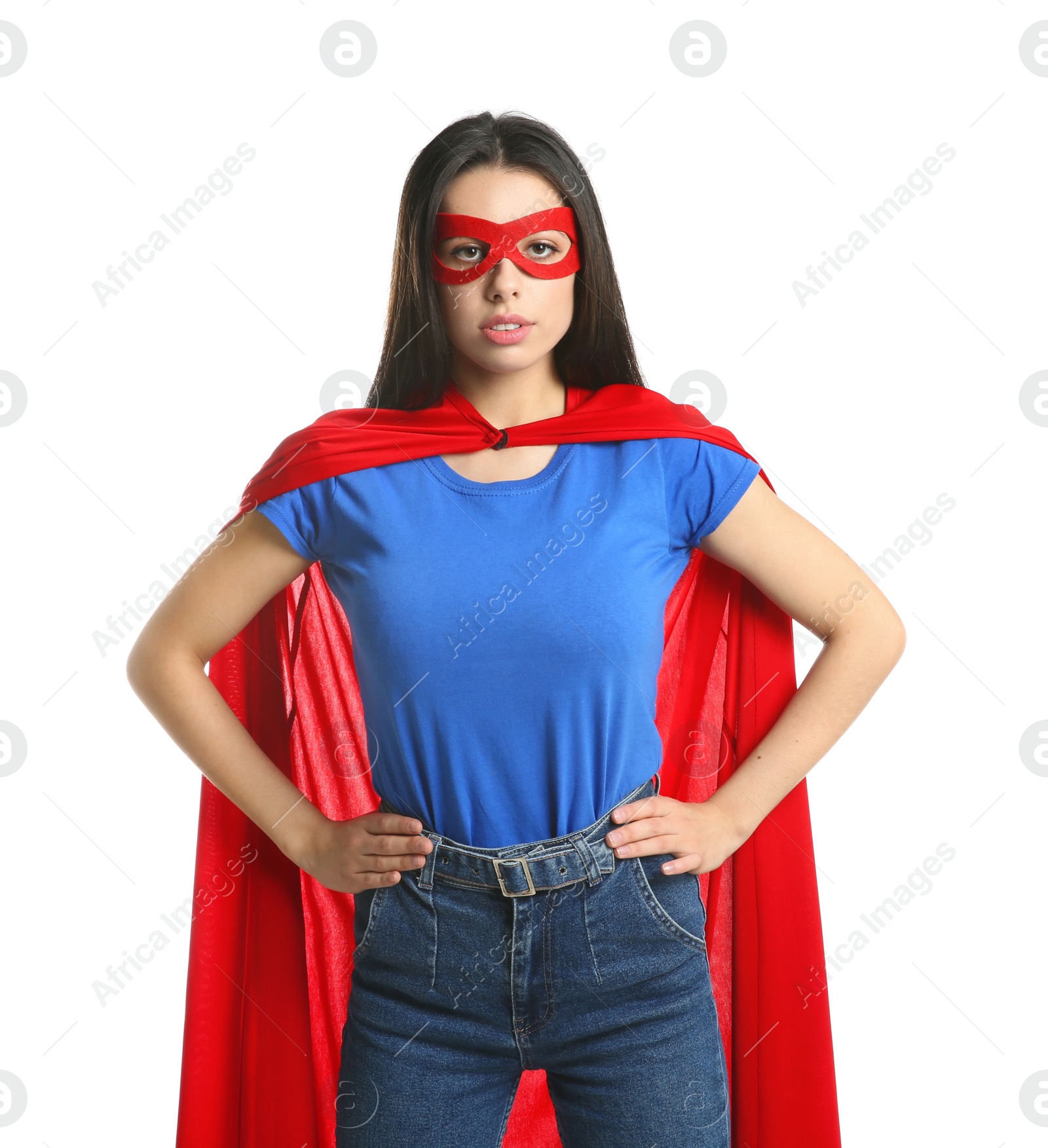 Photo of Confident young woman wearing superhero cape and mask on white background