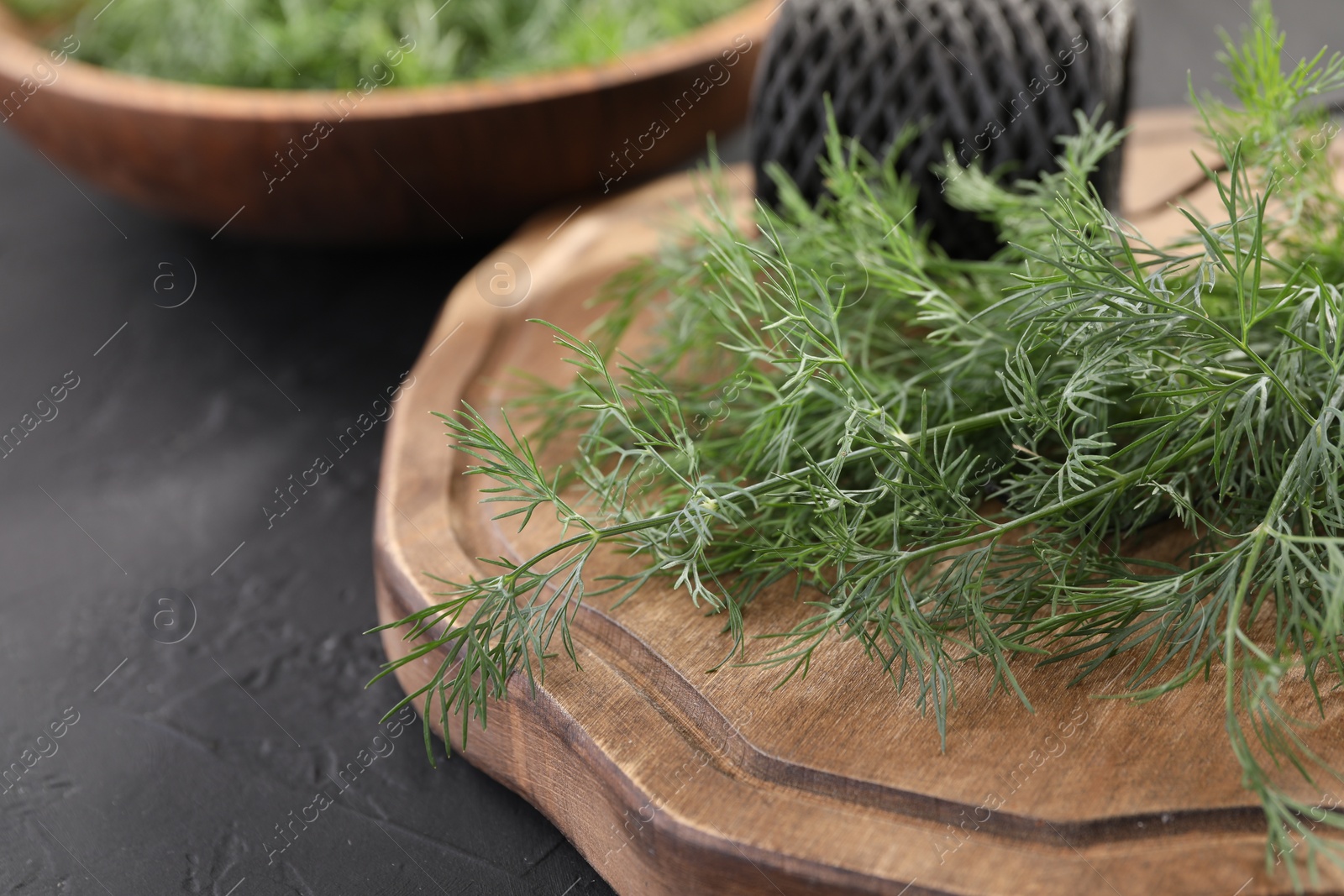 Photo of Fresh dill on grey table, closeup. Space for text