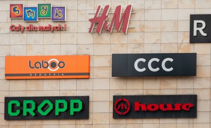 Photo of SIEDLCE, POLAND - AUGUST 30, 2022: Shopping mall with different store brand logos outdoors