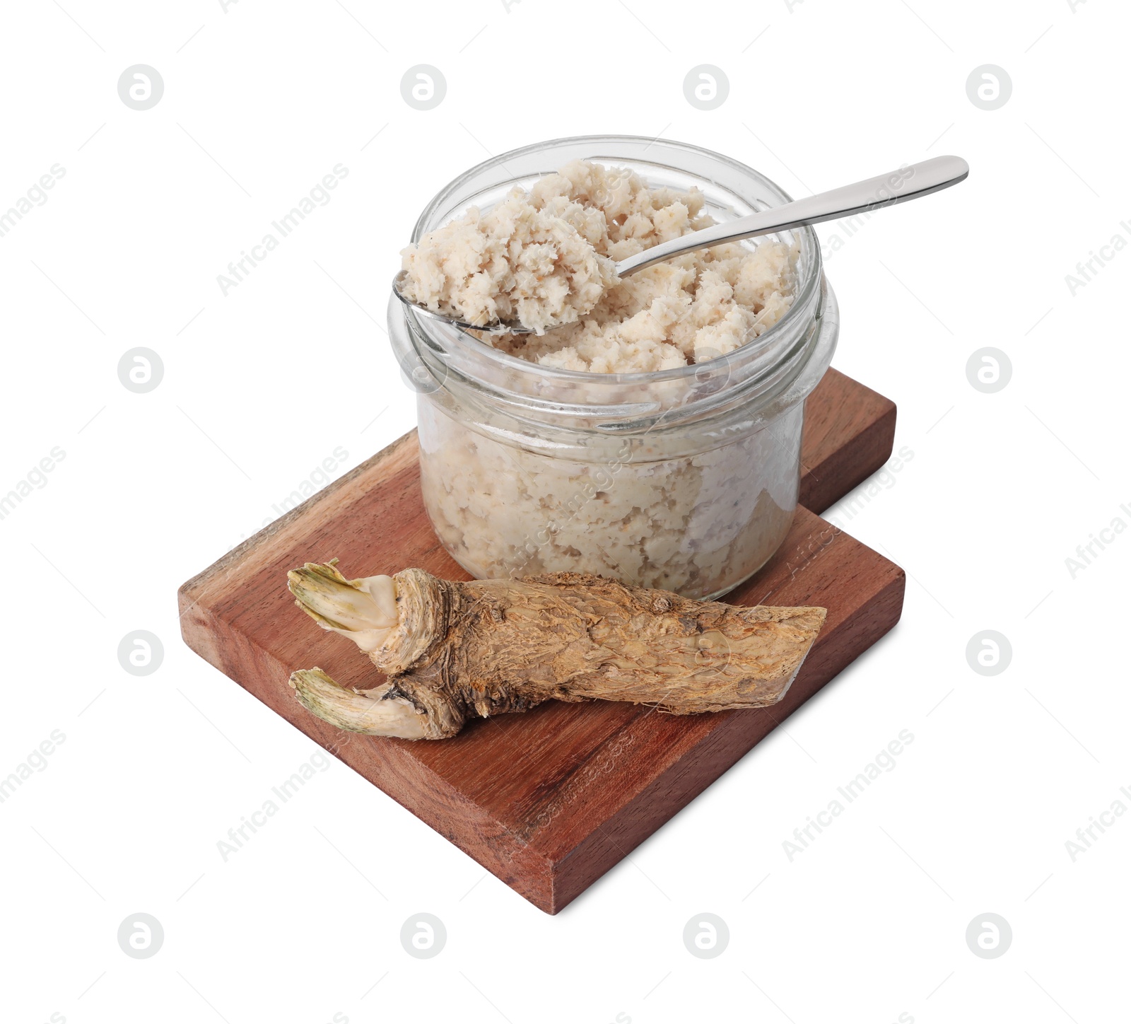 Photo of Wooden board with glass jar of tasty prepared horseradish, spoon and root isolated on white