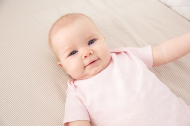 Cute baby girl in crib. Bedtime schedule