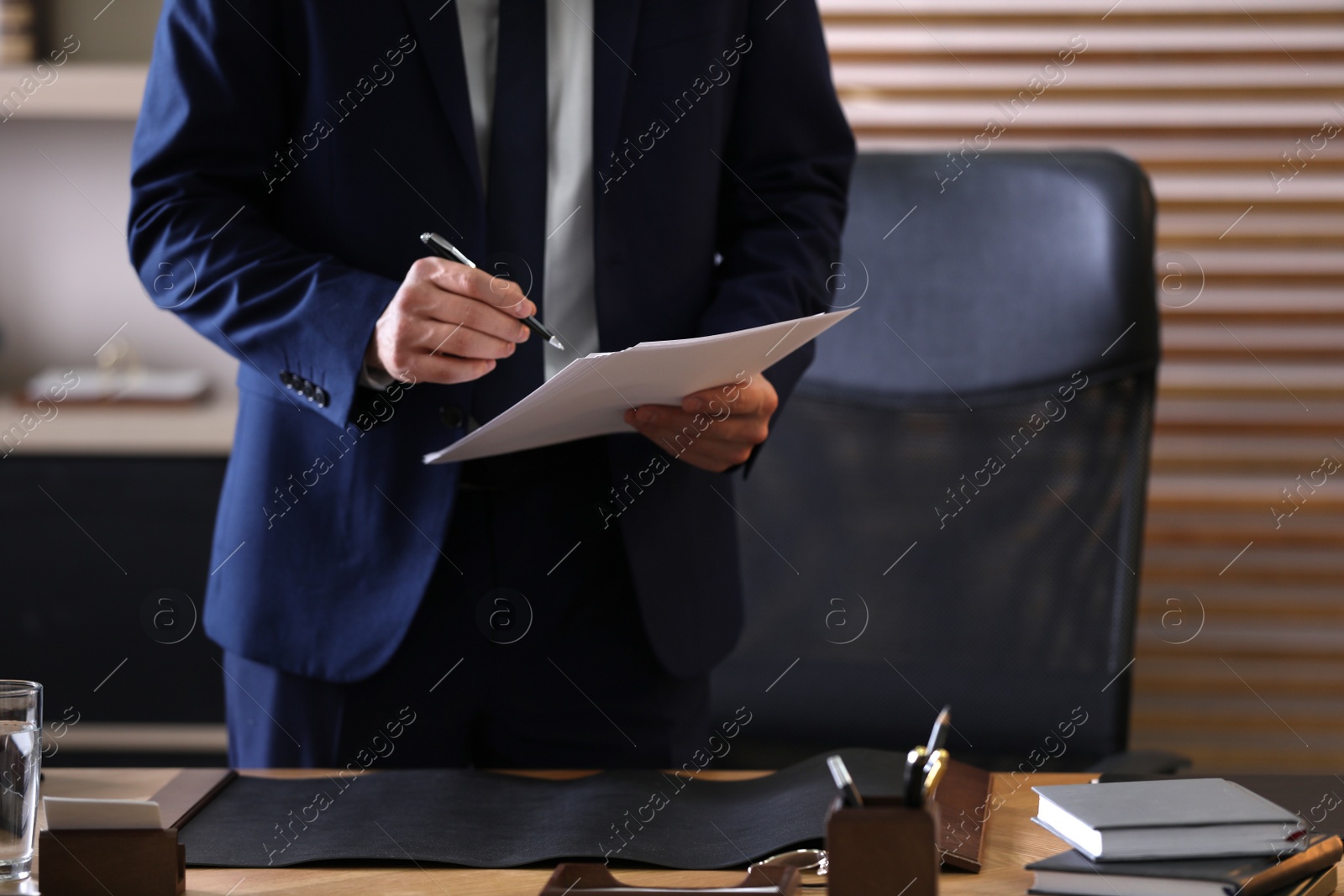 Photo of Male lawyer working at table in office, closeup