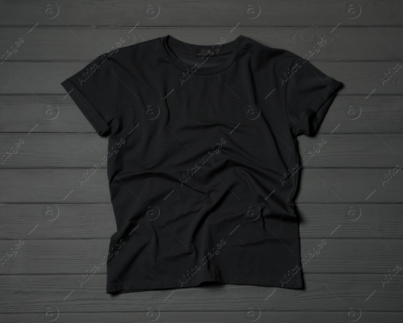 Photo of Stylish black T-shirt on gray wooden table, top view