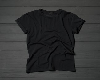 Photo of Stylish black T-shirt on gray wooden table, top view