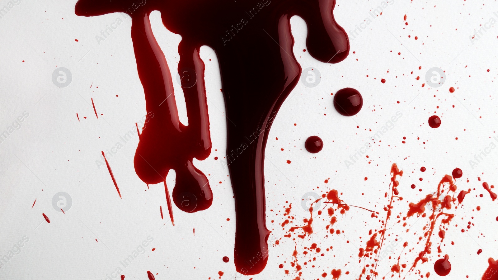 Photo of Stain and splashes of blood on light grey background