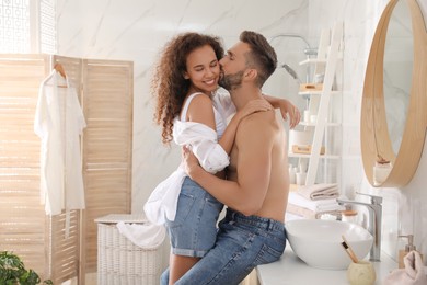 Photo of Lovely couple enjoying each other in bathroom at home