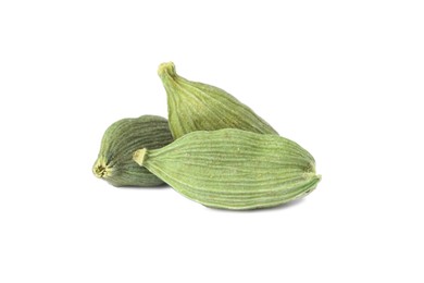 Photo of Dry green cardamom pods on white background
