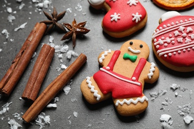 Tasty homemade Christmas cookies and cinnamon on grey table