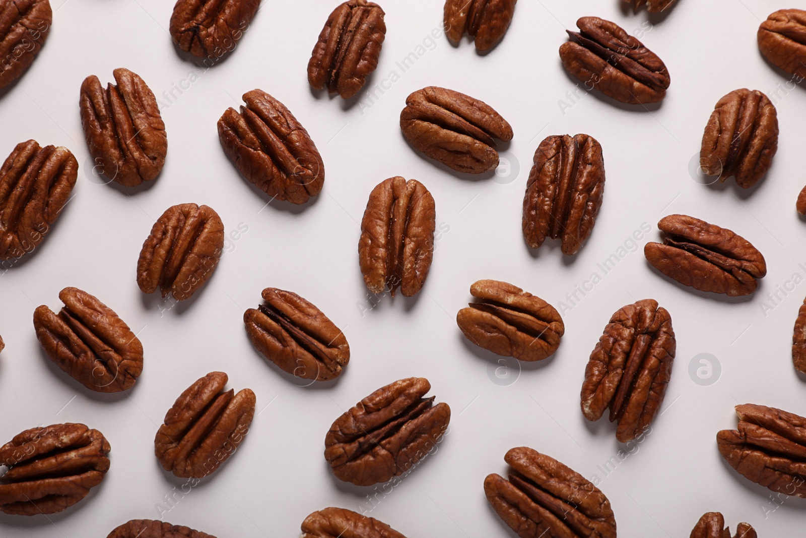 Photo of Delicious fresh pecan nuts on white background, flat lay