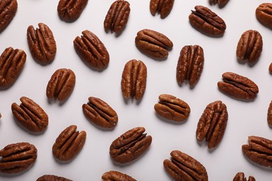 Photo of Delicious fresh pecan nuts on white background, flat lay