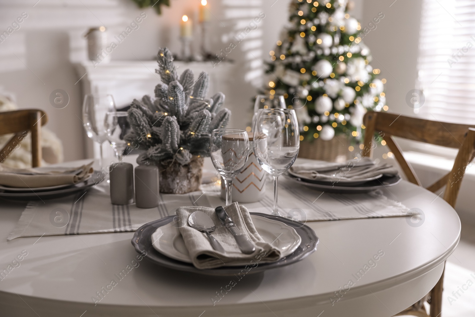 Photo of Festive table setting and beautiful Christmas decor indoors. Interior design