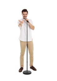 Young handsome man singing in microphone on white background