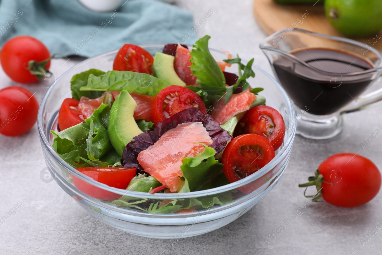 Photo of Vegetable salad with soy sauce on grey table, closeup