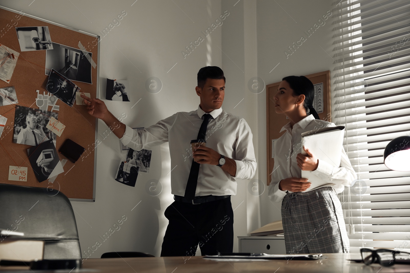 Photo of Professional detectives working on case in office