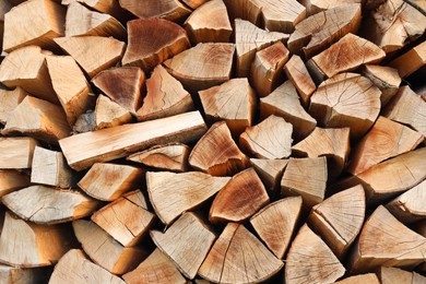 Photo of Stack of chopped firewood as background, closeup