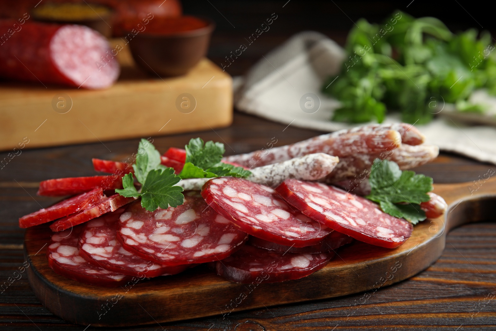 Photo of Different types of sausages served on wooden table, closeup