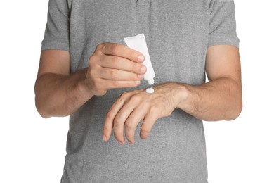 Photo of Man applying cream from tube onto hand on white background, closeup