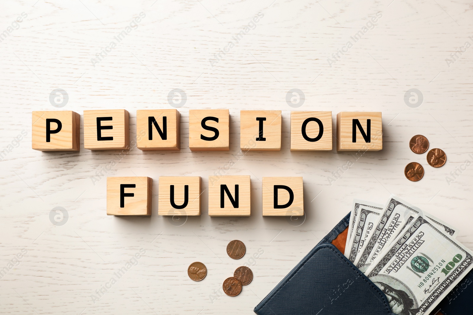 Photo of Cubes with words "PENSION FUND" and money on wooden background, flat lay