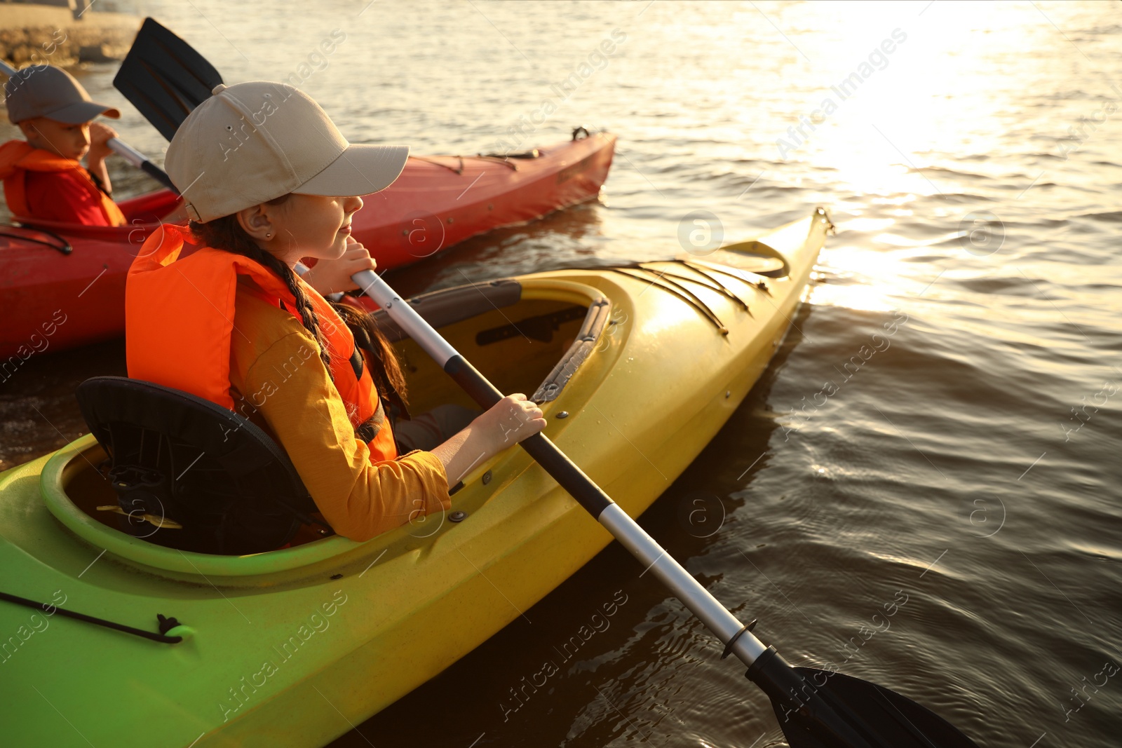 Photo of Little children kayaking on river. Summer camp activity