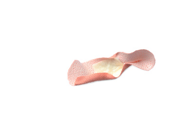 Photo of Used sticking plaster isolated on white. First aid item