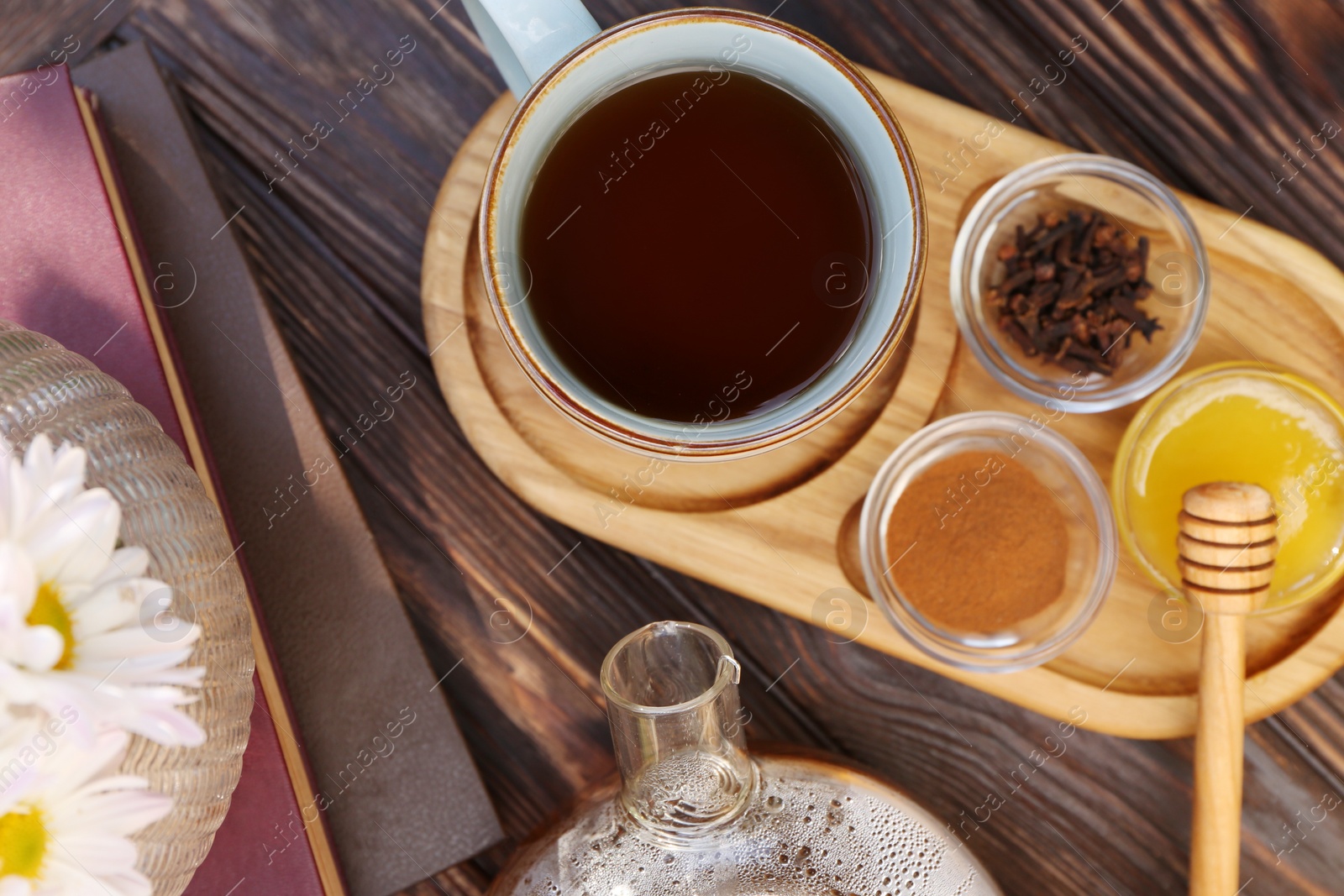 Photo of Tray with delicious tea and ingredients on wooden table, flat lay