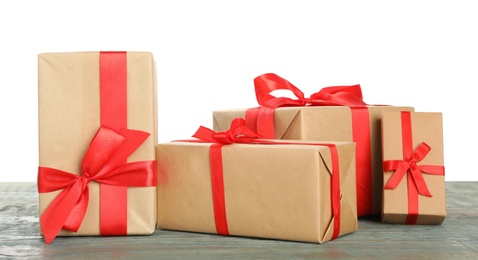 Many Christmas gifts on wooden table against white background