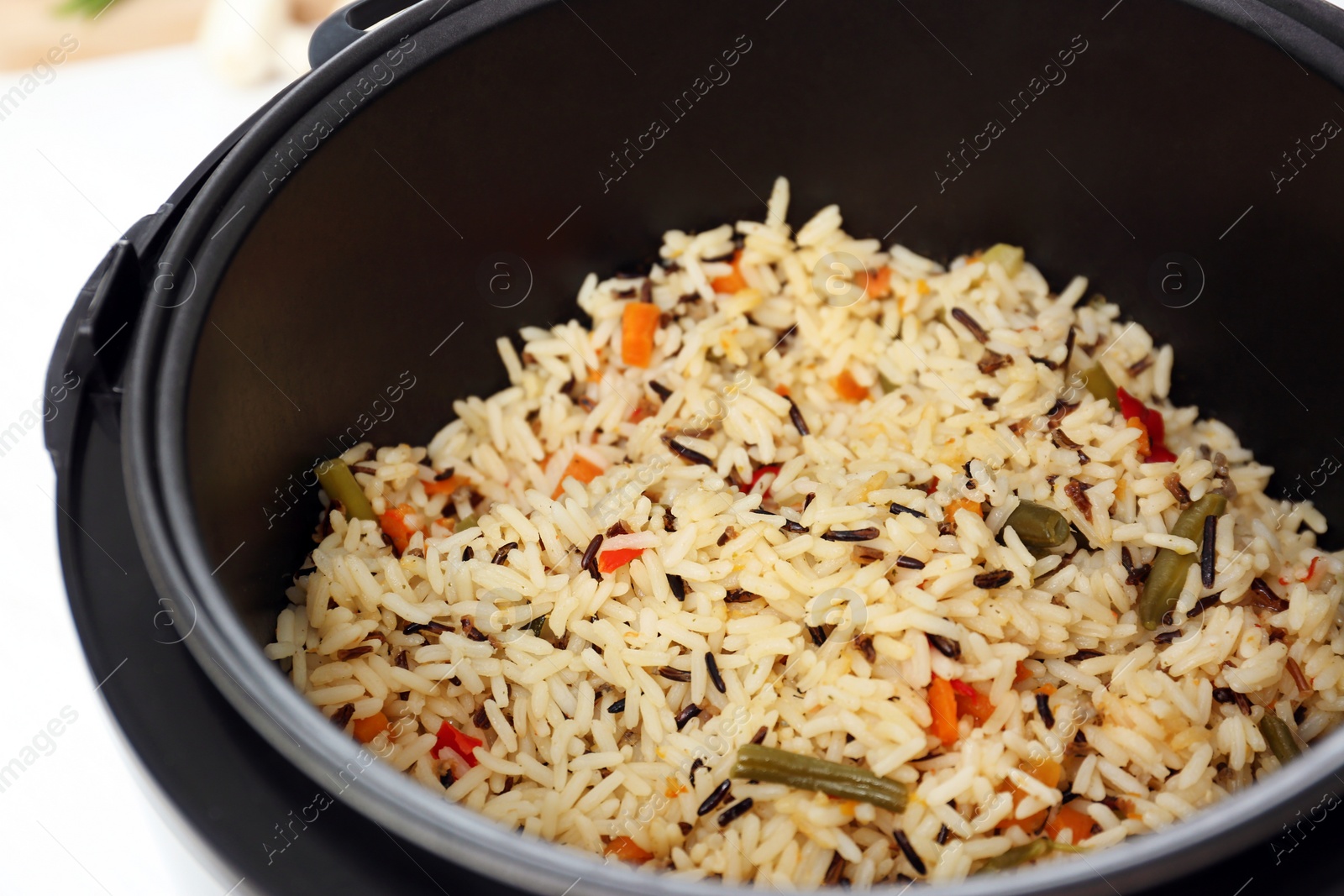 Photo of Prepared rice with vegetables in multi cooker, closeup