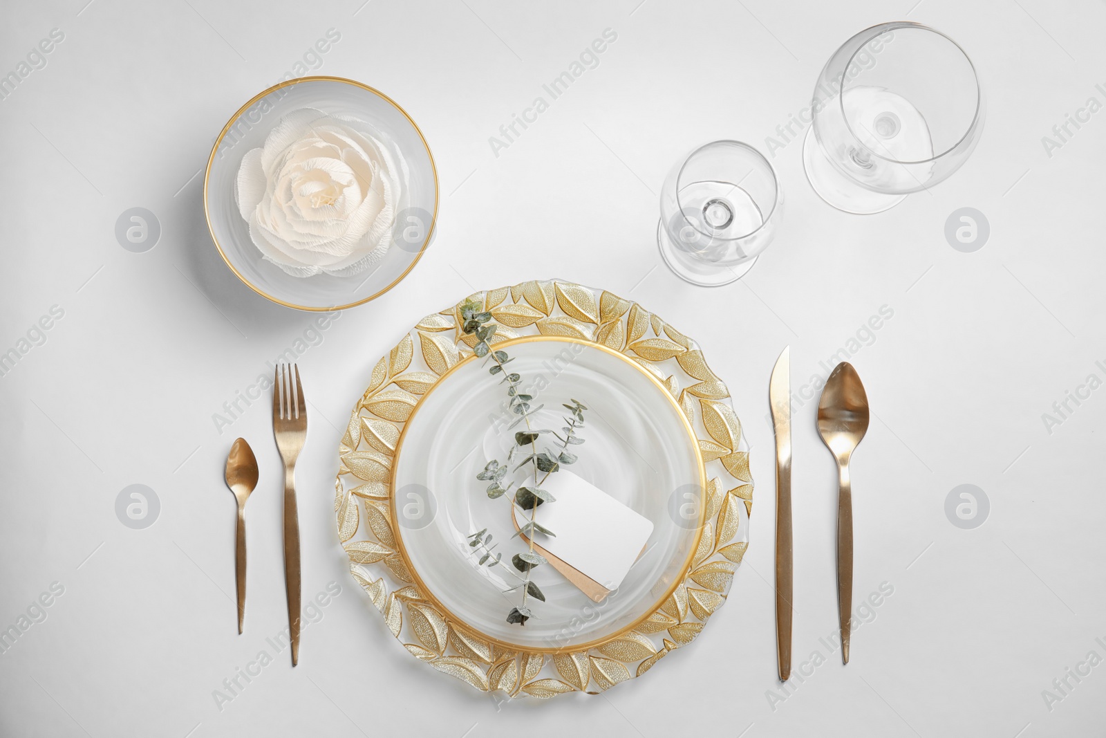 Photo of Elegant table setting on light background, top view