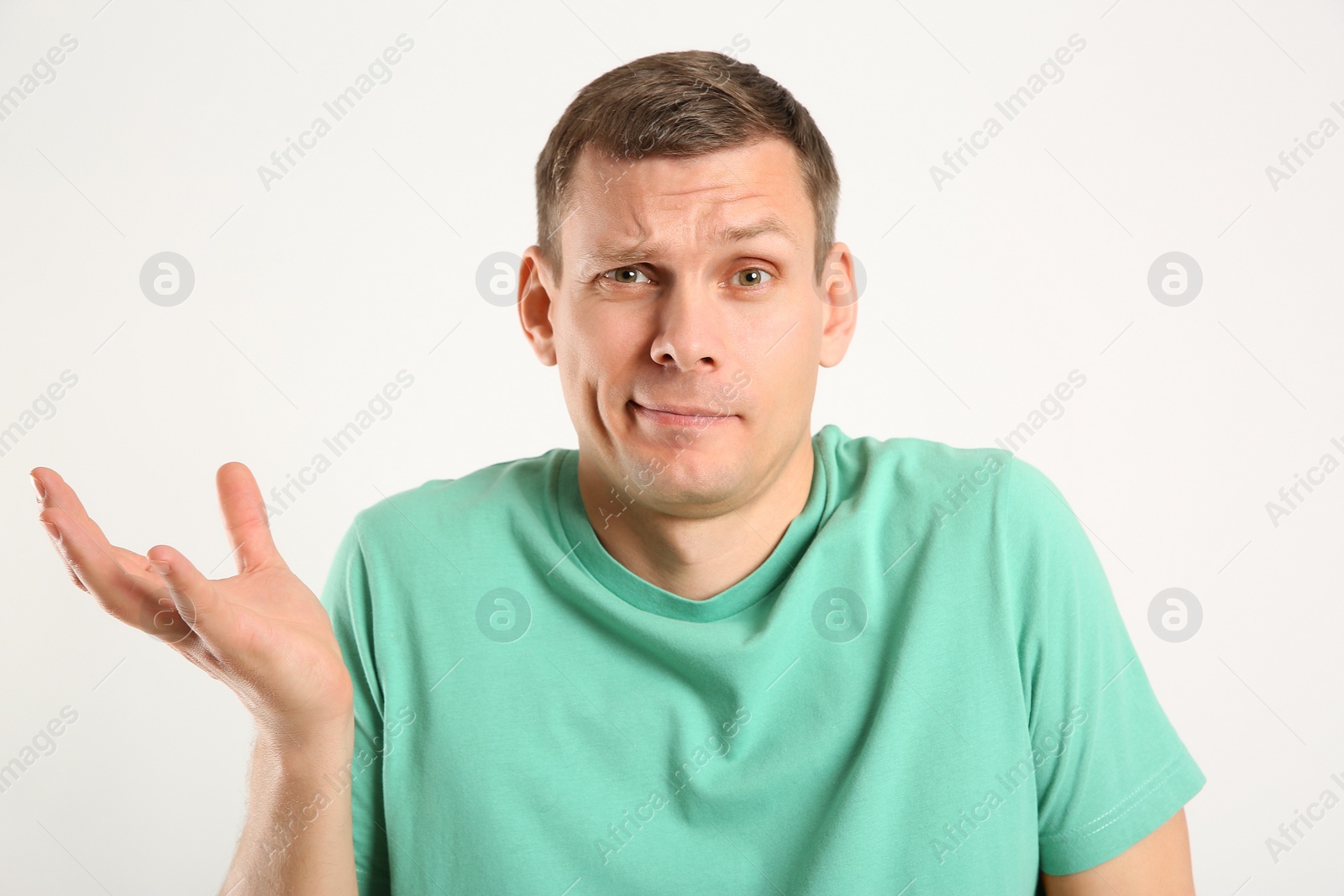 Photo of Emotional man in casual outfit on white background