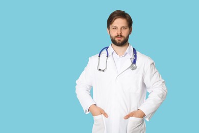 Doctor or medical assistant (male nurse) with stethoscope on turquoise background. Space for text