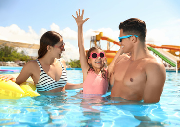 Photo of Happy family in swimming pool. Summer vacation