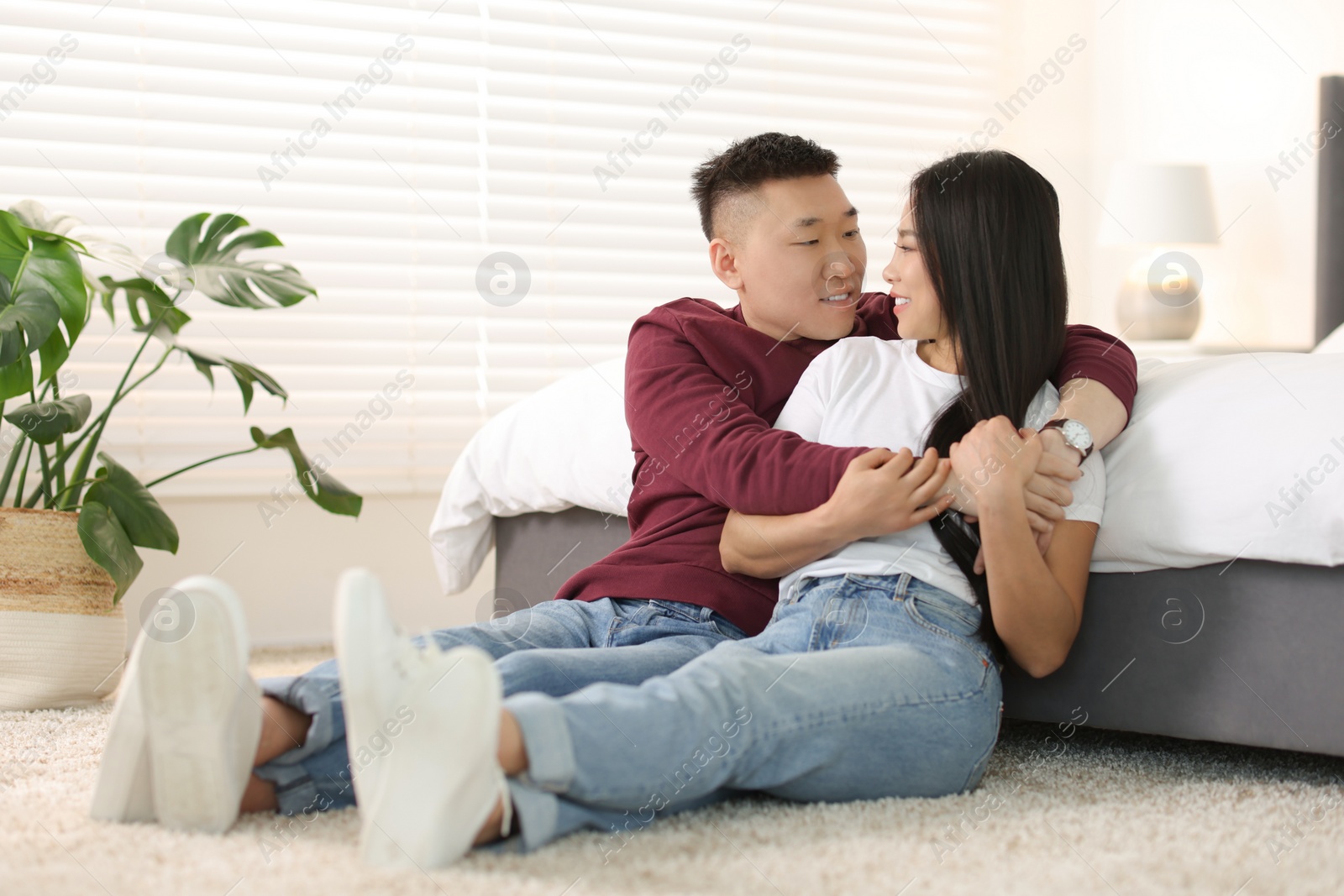 Photo of Lovely young couple on floor at home