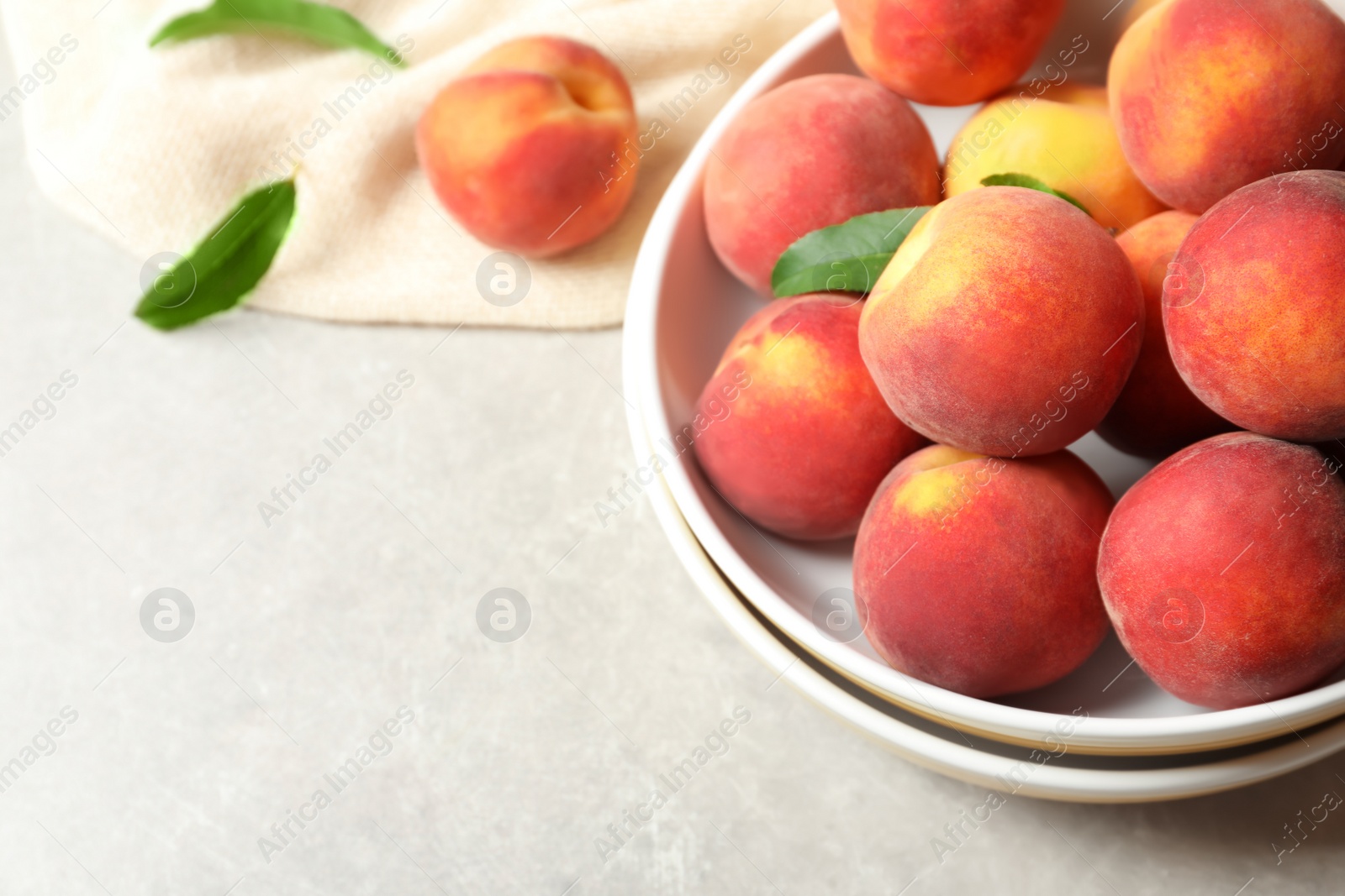 Photo of Plates with fresh sweet peaches on table