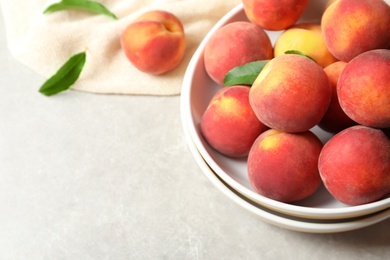 Photo of Plates with fresh sweet peaches on table