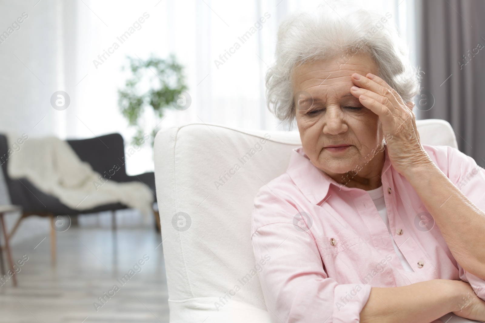 Photo of Portrait of mature woman in living room