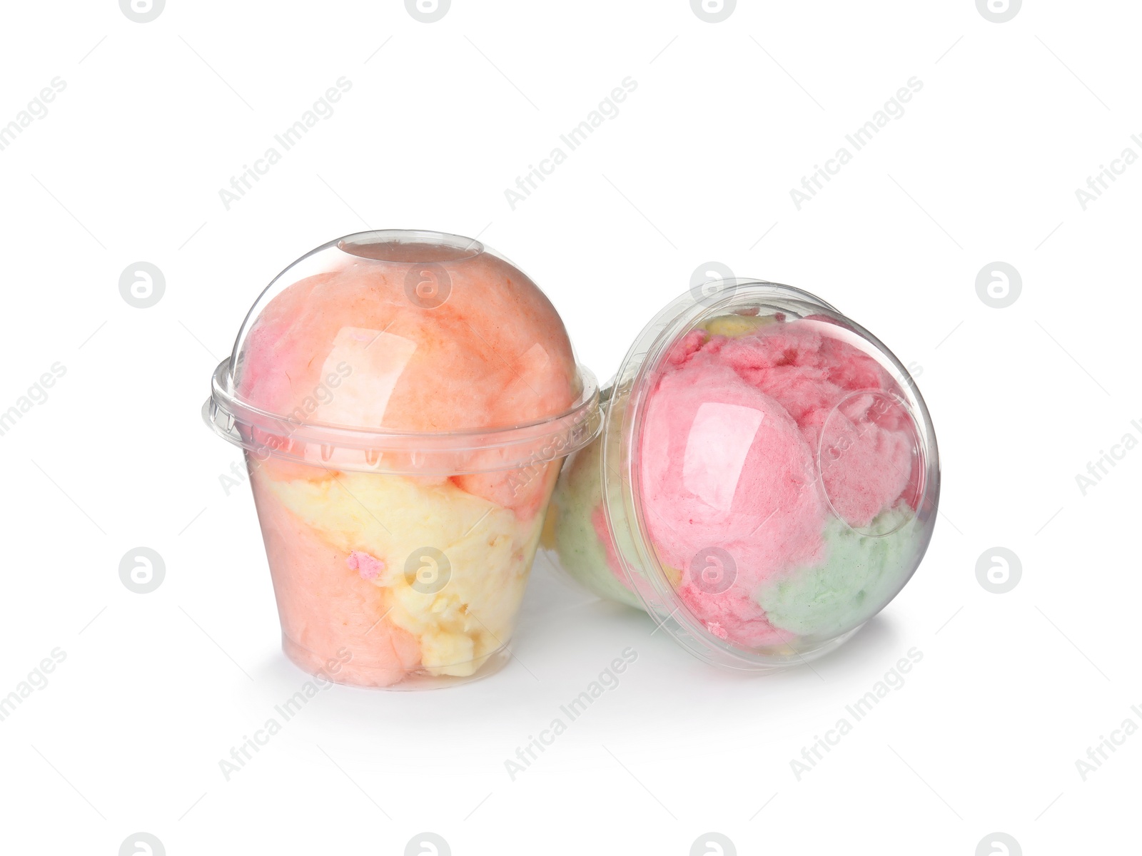 Photo of Yummy cotton candy in plastic cups on white background