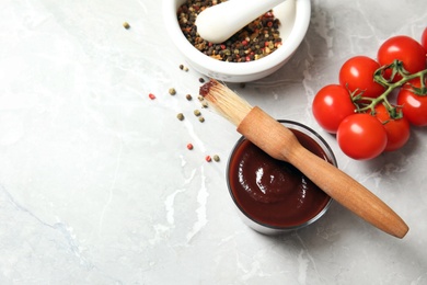 Photo of Flat lay composition with barbecue sauce and tomatoes on table. Space for text