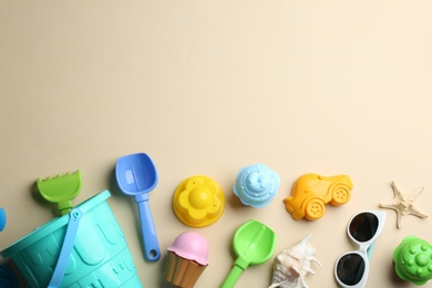 Photo of Flat lay composition with bright beach toys on color background. Space for text